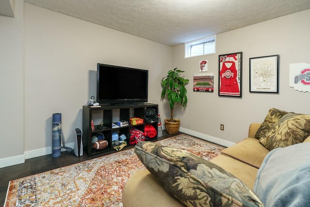 living room with baseboards and a textured ceiling