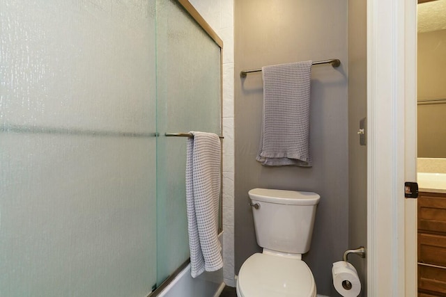 full bath with vanity, toilet, and combined bath / shower with glass door