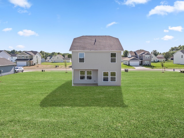 rear view of property with a yard and a residential view