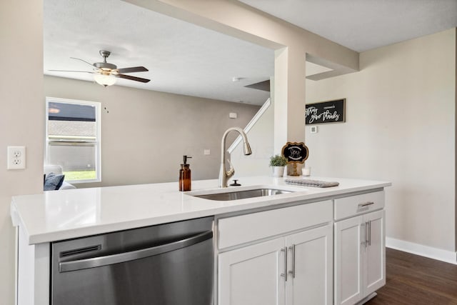 kitchen featuring dark wood-style flooring, a sink, light countertops, white cabinets, and dishwasher