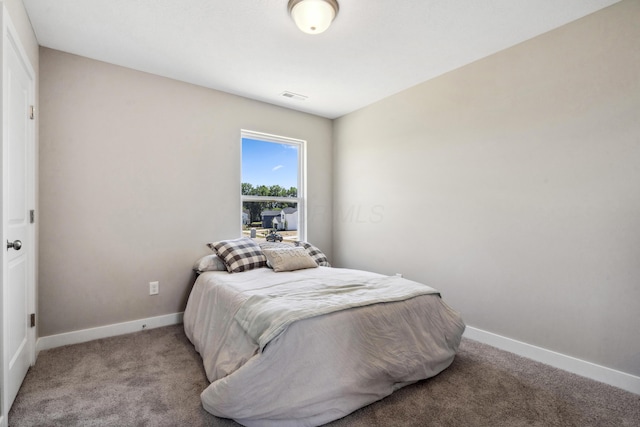 bedroom with light carpet, visible vents, and baseboards