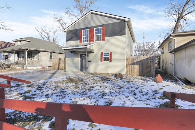 traditional-style house featuring fence