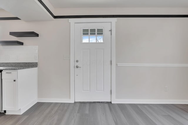 entryway with light wood-type flooring and baseboards