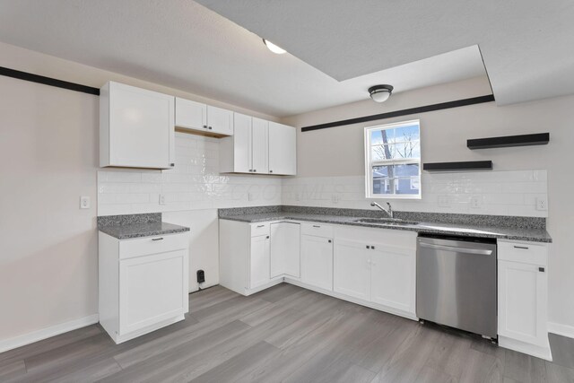 kitchen featuring a sink, white cabinetry, and dishwasher