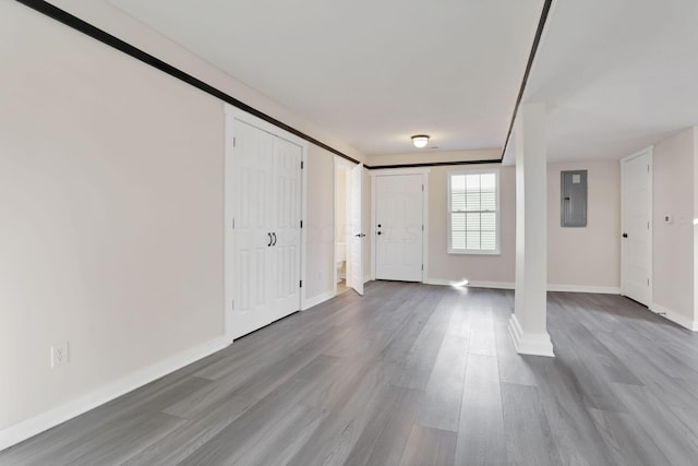 entrance foyer with electric panel, baseboards, and wood finished floors