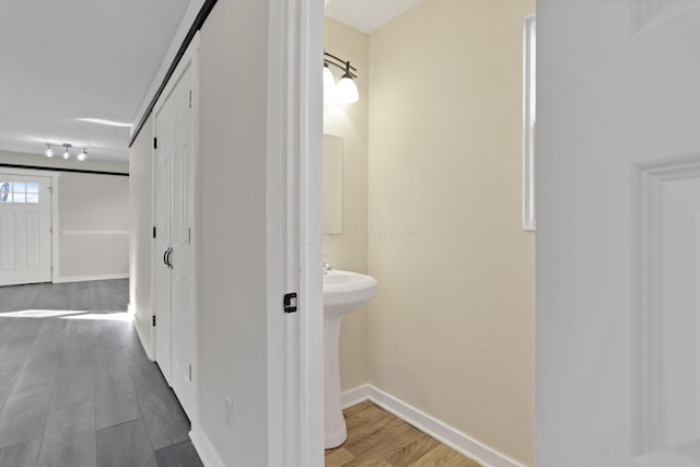 bathroom with wood finished floors and baseboards