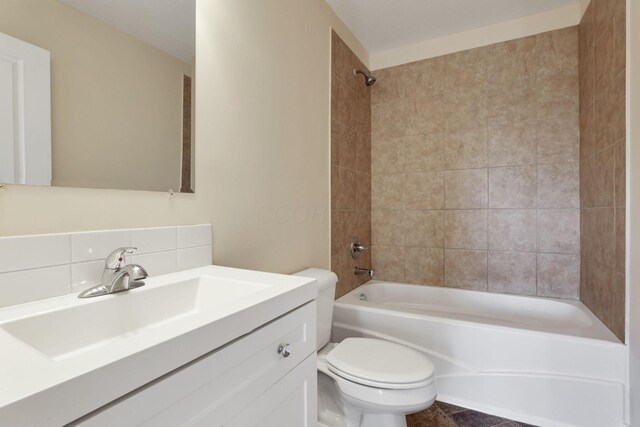 full bathroom with vanity, tasteful backsplash, shower / tub combination, and toilet