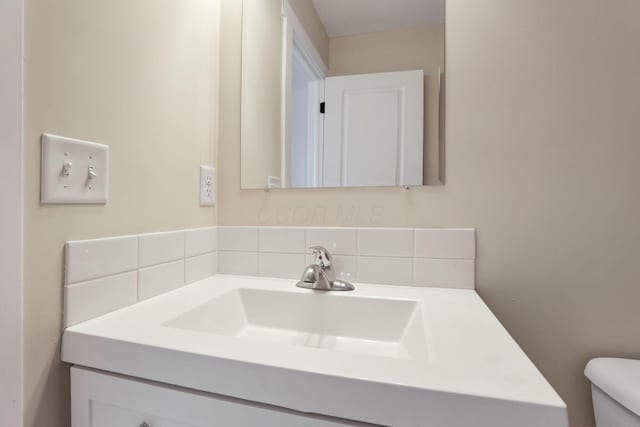 bathroom with toilet and vanity