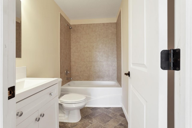 full bathroom with shower / bathtub combination, stone finish floor, vanity, and toilet