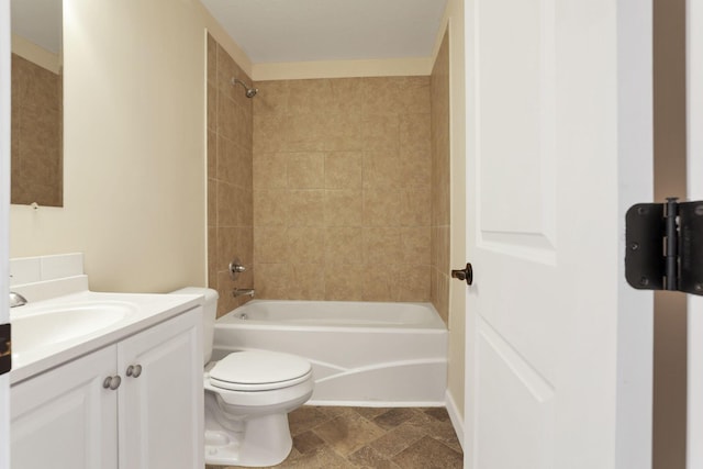 full bath featuring toilet, stone finish flooring, bathtub / shower combination, and vanity