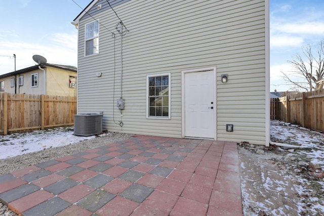 rear view of house with a patio area, fence, and central AC