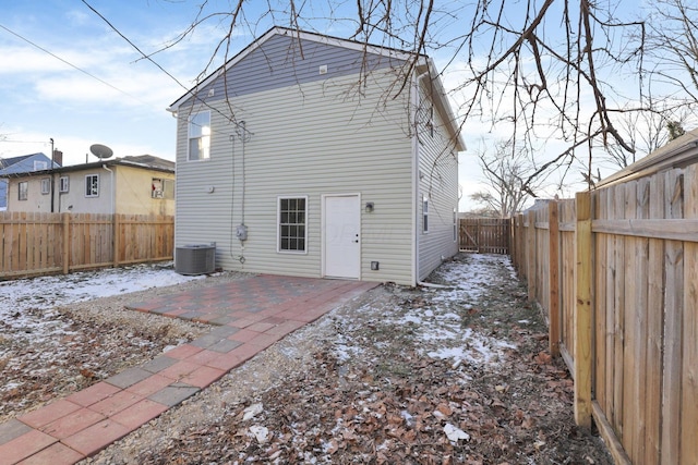 rear view of house with a patio, a fenced backyard, and central air condition unit