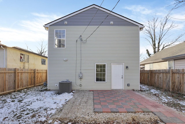 rear view of property featuring central air condition unit, a fenced backyard, and a patio