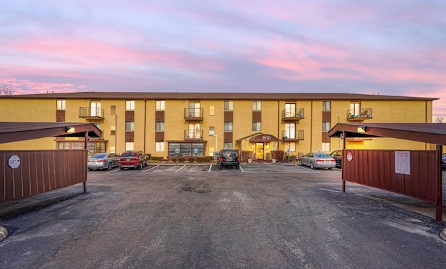 property at dusk with uncovered parking