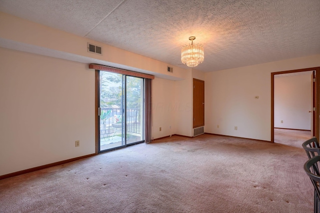 unfurnished room featuring a chandelier, visible vents, and light colored carpet