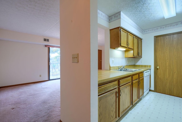 kitchen with visible vents, white dishwasher, light countertops, a textured ceiling, and a sink