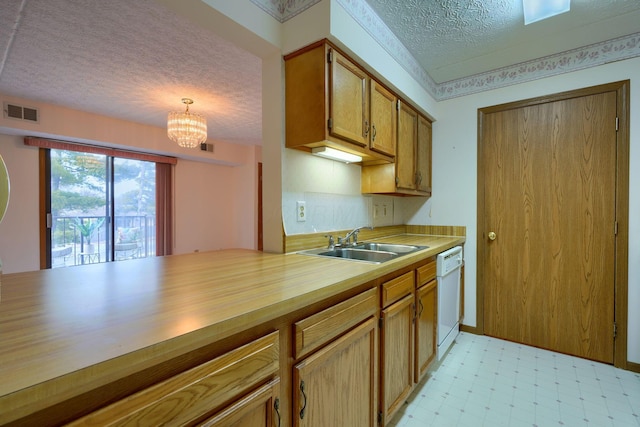 kitchen featuring light floors, visible vents, a sink, a textured ceiling, and dishwasher