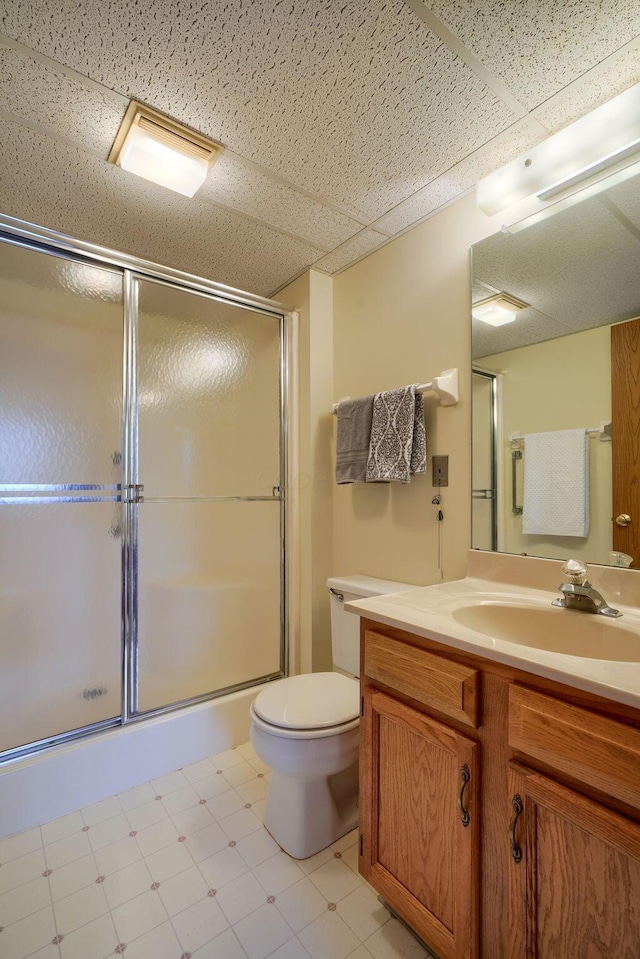 full bathroom with toilet, a shower stall, vanity, and tile patterned floors