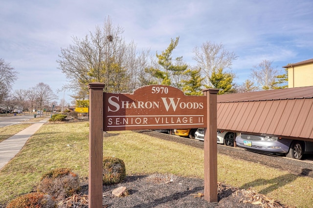 community sign featuring a lawn