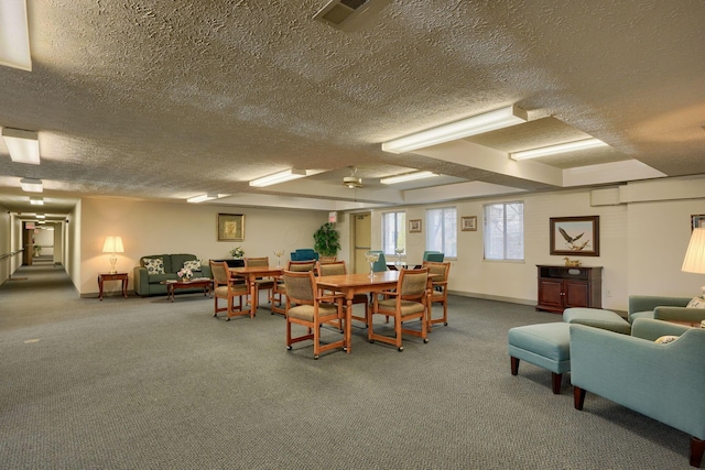 dining area with carpet, visible vents, and a textured ceiling