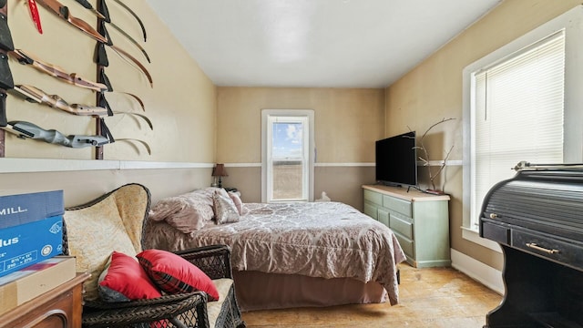 bedroom featuring baseboards and wood finished floors