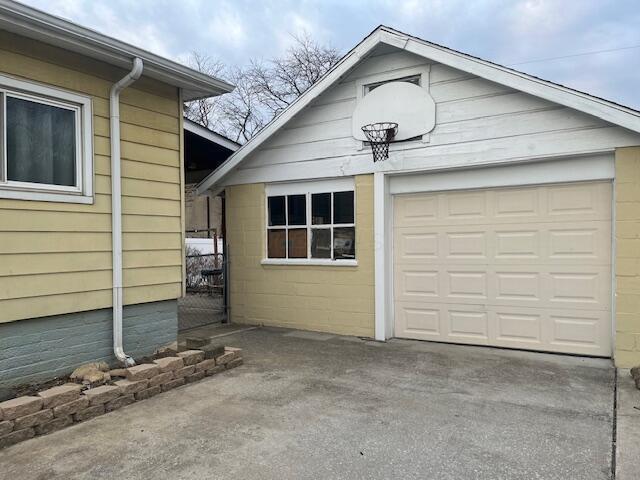 view of property exterior with a garage and an outdoor structure