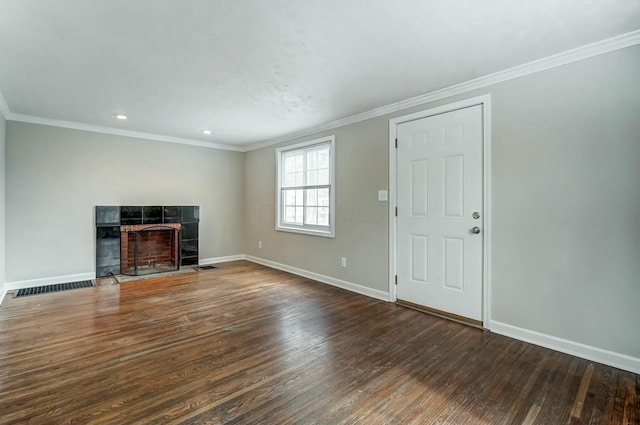 unfurnished living room with a tile fireplace, baseboards, and wood finished floors