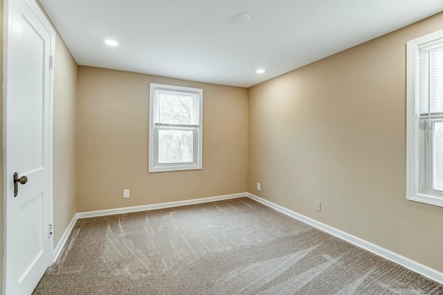 carpeted spare room featuring recessed lighting and baseboards