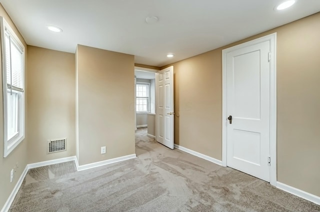 empty room with recessed lighting, carpet flooring, visible vents, and baseboards