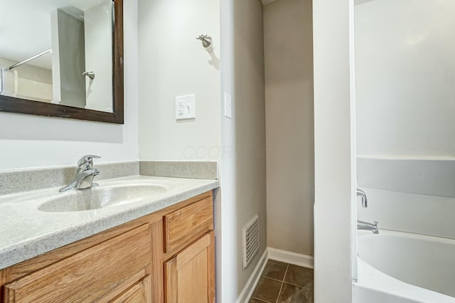 bathroom featuring visible vents, a bathing tub, tile patterned flooring, walk in shower, and vanity