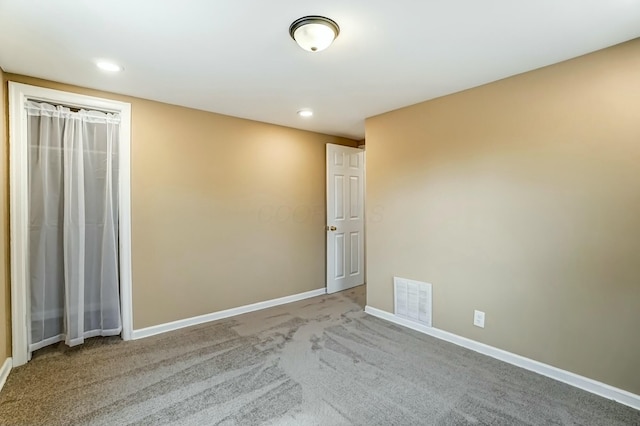 unfurnished bedroom featuring baseboards, visible vents, carpet flooring, and recessed lighting