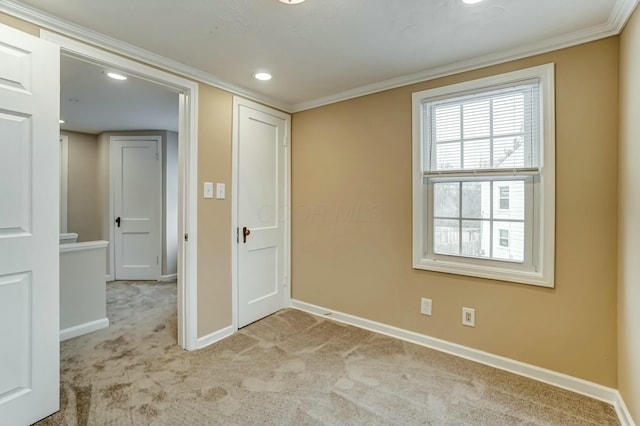 carpeted empty room with crown molding, recessed lighting, and baseboards