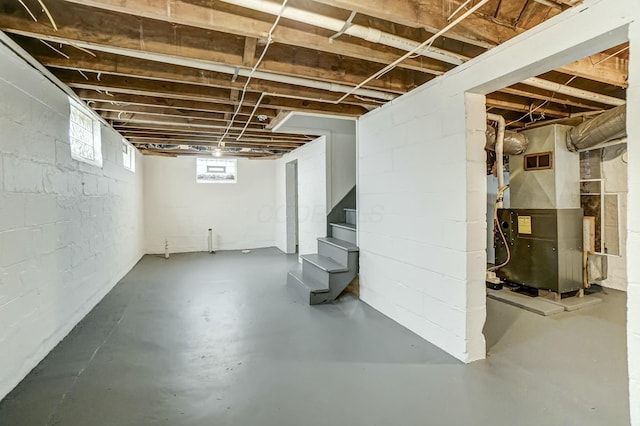 basement with stairway and heating unit