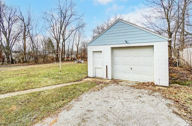 detached garage with gravel driveway