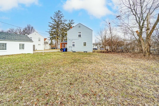 back of house featuring a yard