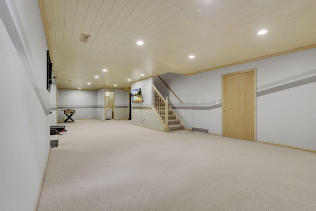 finished below grade area with visible vents, wooden ceiling, stairs, carpet flooring, and recessed lighting