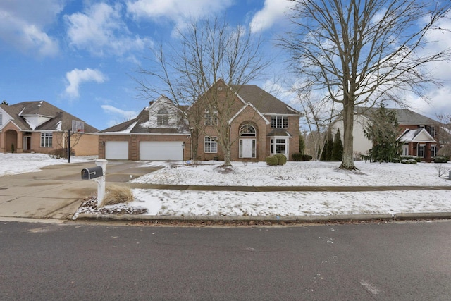 view of front facade featuring a garage, driveway, and brick siding