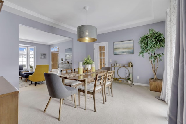 dining room with light carpet and baseboards