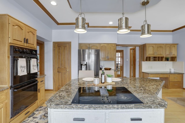 kitchen with a kitchen island, dark stone counters, black appliances, light wood finished floors, and crown molding