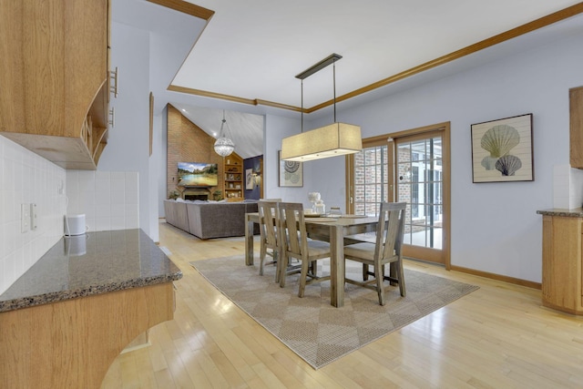 dining space featuring light wood-type flooring and baseboards