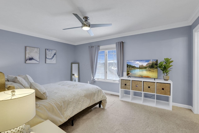 carpeted bedroom featuring ceiling fan, ornamental molding, and baseboards