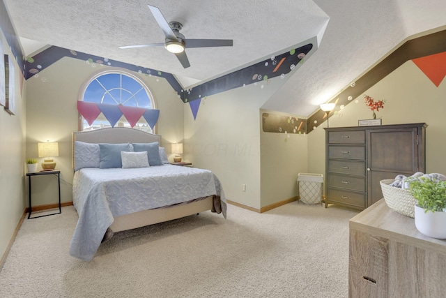 bedroom featuring ceiling fan, a textured ceiling, light colored carpet, baseboards, and vaulted ceiling