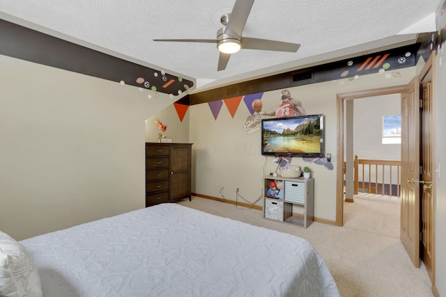 bedroom featuring baseboards, visible vents, light carpet, and a textured ceiling