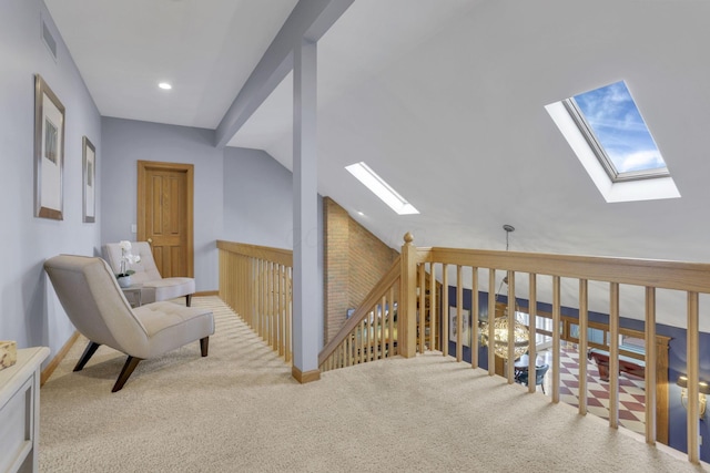 interior space featuring carpet, recessed lighting, visible vents, lofted ceiling with skylight, and baseboards