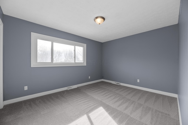 unfurnished room featuring carpet flooring, baseboards, and visible vents