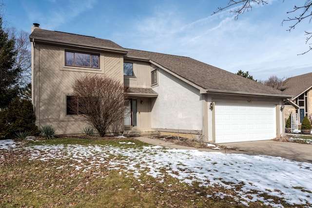 traditional-style home featuring a chimney, an attached garage, a shingled roof, and driveway