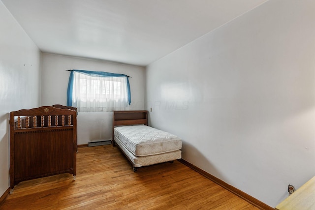 bedroom featuring baseboards and light wood finished floors