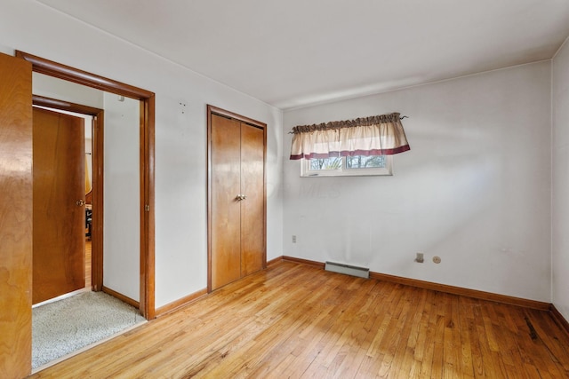 unfurnished bedroom with baseboards, a closet, visible vents, and light wood-style floors