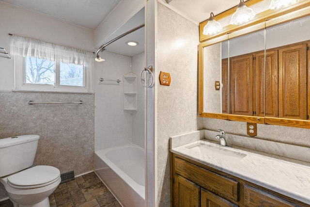 bathroom with shower / bathtub combination, visible vents, toilet, stone finish floor, and vanity