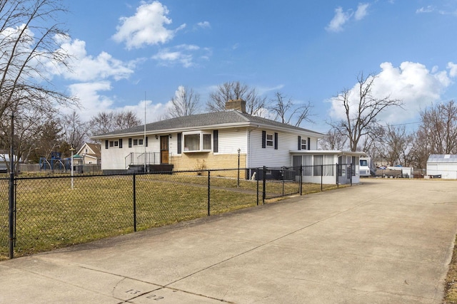 single story home with a fenced front yard, brick siding, driveway, a chimney, and a front yard